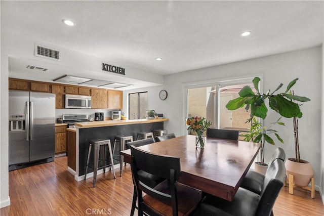 15230 Roxford St Unit 61, Sylmar, CA 91342 - dining room with light wood-style floors and recessed lighting