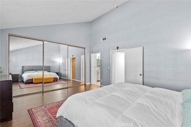 15230 Roxford St Unit 61, Sylmar, CA 91342 - bedroom featuring wood finished floors, high vaulted ceiling, a closet, and ensuite bathroom