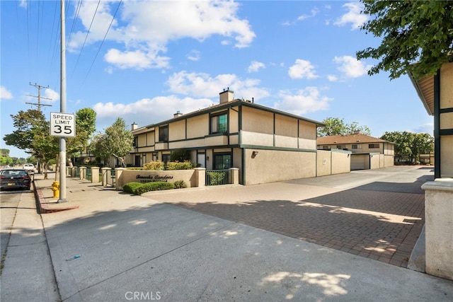 15230 Roxford St Unit 61, Sylmar, CA 91342 - view of front of home featuring a gate and stucco siding