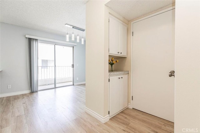 12411 Osborne St Unit 114, Pacoima, CA 91331 - washroom with light wood-type flooring and a textured ceiling
