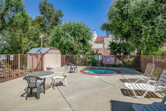 12411 Osborne St Unit 114, Pacoima, CA 91331 - view of swimming pool featuring a community hot tub, a patio area, and a shed