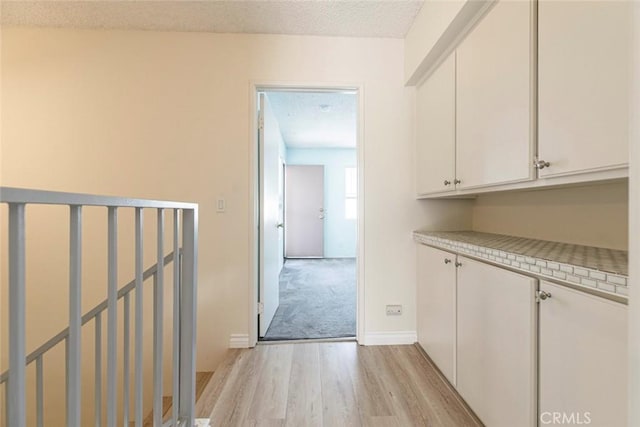 12411 Osborne St Unit 114, Pacoima, CA 91331 - hall featuring light wood-style flooring and a textured ceiling
