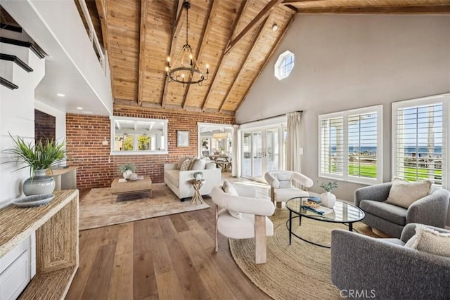1780 Ocean Blvd, Pismo Beach, CA 93449 - living room featuring a wood ceiling with exposed beams, hardwood / wood-style floors, brick wall, high vaulted ceiling, and plenty of natural light