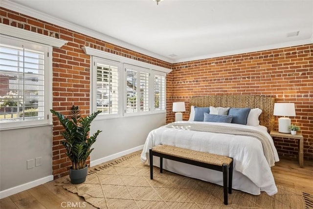 1780 Ocean Blvd, Pismo Beach, CA 93449 - bedroom featuring multiple windows, wood finished floors, brick wall, and crown molding