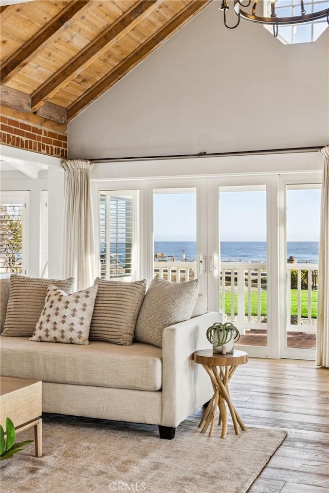 1780 Ocean Blvd, Pismo Beach, CA 93449 - living area with a wood ceiling with exposed beams, high vaulted ceiling, healthy amount of natural light, a water view, and hardwood / wood-style floors