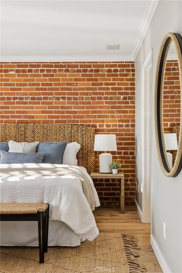 1780 Ocean Blvd, Pismo Beach, CA 93449 - bedroom with ornamental molding, wood finished floors, and brick wall