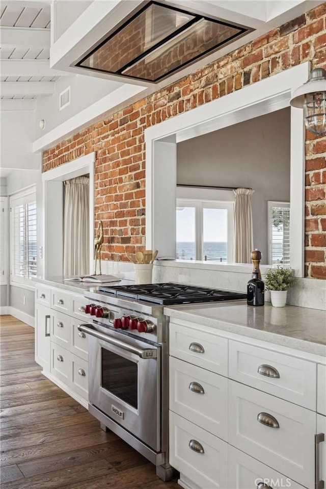 1780 Ocean Blvd, Pismo Beach, CA 93449 - kitchen featuring designer range, white cabinetry, brick wall, light countertops, and dark wood-style floors