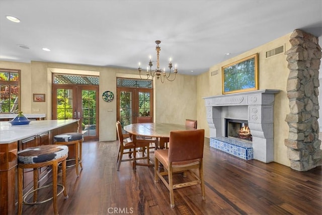 79 Dapplegray Ln, Rolling Hills Estates, CA 90274 - dining area with french doors, dark wood finished floors, a lit fireplace, a chandelier, and recessed lighting