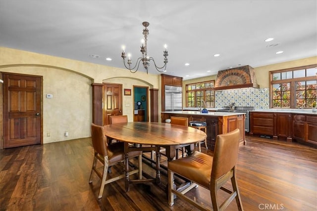 79 Dapplegray Ln, Rolling Hills Estates, CA 90274 - dining area featuring dark wood finished floors, a chandelier, recessed lighting, and arched walkways