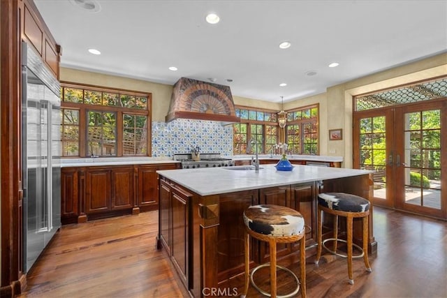 79 Dapplegray Ln, Rolling Hills Estates, CA 90274 - kitchen with french doors, custom range hood, built in fridge, wood finished floors, and recessed lighting