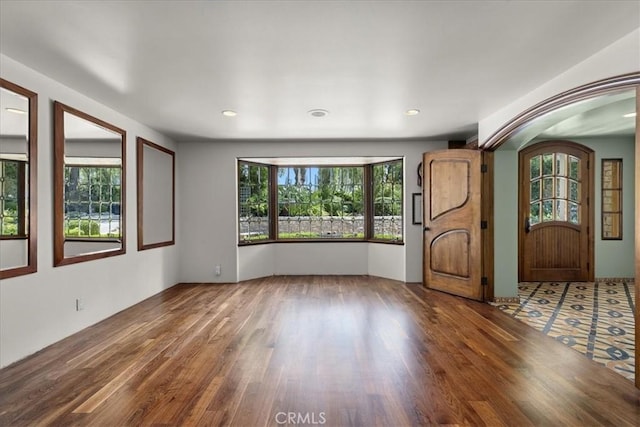 79 Dapplegray Ln, Rolling Hills Estates, CA 90274 - spare room featuring wood finished floors, arched walkways, and recessed lighting