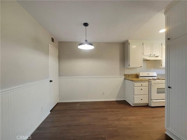 28021 Sarabande Ln Unit 1209, Canyon Country, CA 91387 - kitchen with white gas stove, under cabinet range hood, dark wood-style floors, a wainscoted wall, and white cabinets