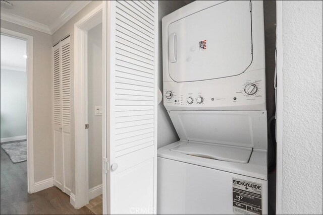 2358 Via Mariposa E Unit B, Laguna Woods, CA 92637 - laundry area with stacked washer / drying machine, crown molding, and wood finished floors