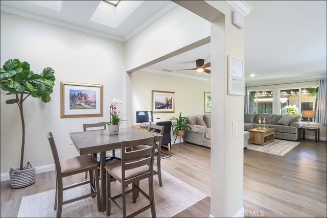 2358 Via Mariposa E Unit B, Laguna Woods, CA 92637 - dining space with wood finished floors, crown molding, a skylight, and ceiling fan