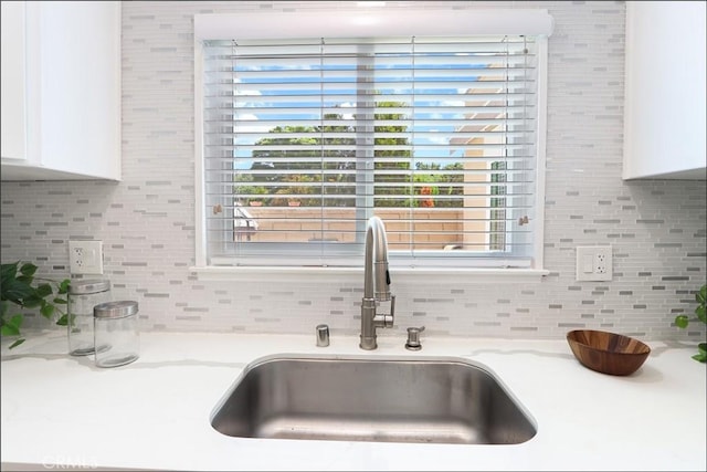 2358 Via Mariposa E Unit B, Laguna Woods, CA 92637 - kitchen view of decorative backsplash, white cabinetry, and light stone countertops