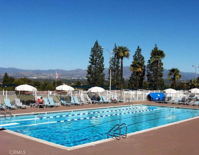 2358 Via Mariposa E Unit B, Laguna Woods, CA 92637 - community pool featuring a mountain view and a patio area