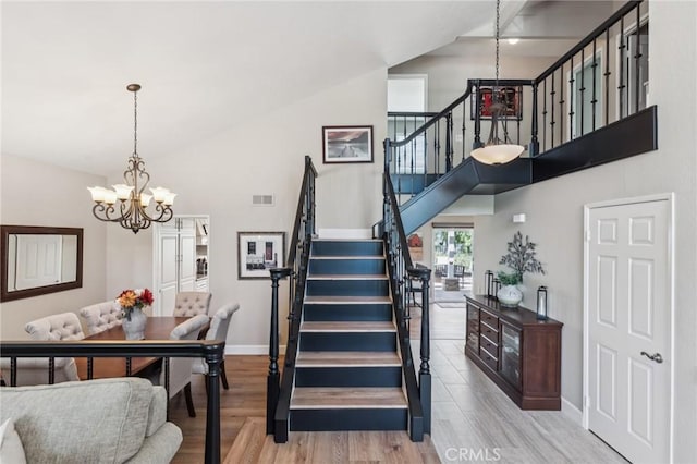 27201 Via Aurora, Mission Viejo, CA 92691 - staircase with a chandelier, high vaulted ceiling, and wood finished floors