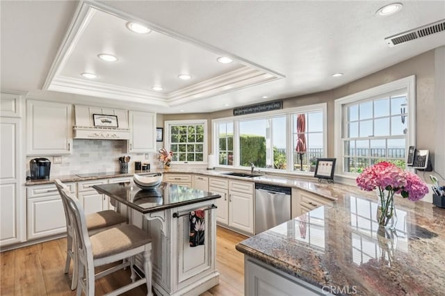 27201 Via Aurora, Mission Viejo, CA 92691 - kitchen with dishwasher, a raised ceiling, dark stone countertops, light wood finished floors, and white cabinets