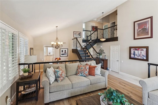 27201 Via Aurora, Mission Viejo, CA 92691 - living room featuring wood finished floors, a chandelier, stairway, and high vaulted ceiling