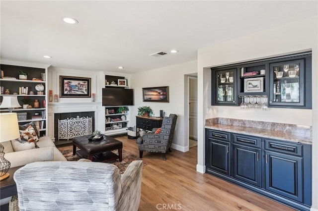 27201 Via Aurora, Mission Viejo, CA 92691 - living area with a dry bar, light wood-style flooring, recessed lighting, and a fireplace