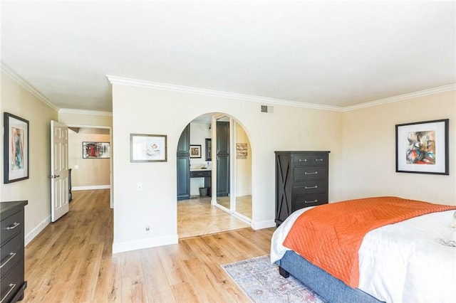 27201 Via Aurora, Mission Viejo, CA 92691 - bedroom featuring arched walkways, light wood-style flooring, and ornamental molding