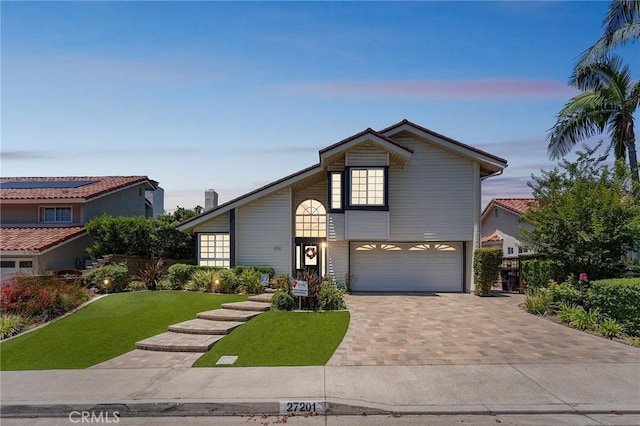 27201 Via Aurora, Mission Viejo, CA 92691 - view of front of home featuring an attached garage, a front yard, and decorative driveway