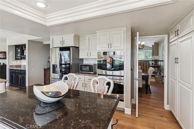 27201 Via Aurora, Mission Viejo, CA 92691 - dining room featuring light wood-type flooring, a chandelier, ornamental molding, and recessed lighting