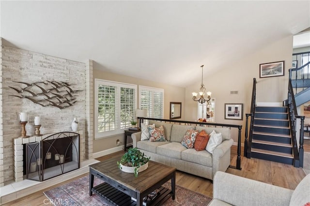 27201 Via Aurora, Mission Viejo, CA 92691 - living area with plenty of natural light, wood finished floors, vaulted ceiling, stairway, and a chandelier
