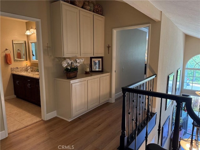 27201 Via Aurora, Mission Viejo, CA 92691 - hall with light wood-type flooring and an upstairs landing