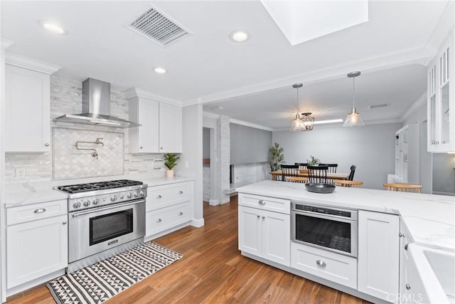 1915 Mariners Dr, Newport Beach, CA 92660 - kitchen featuring high end range, wall chimney exhaust hood, tasteful backsplash, crown molding, and white cabinets