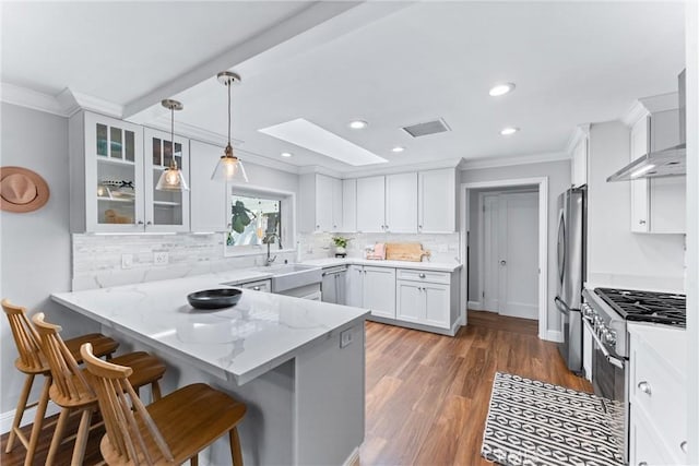 1915 Mariners Dr, Newport Beach, CA 92660 - kitchen with stainless steel appliances, crown molding, a peninsula, white cabinetry, and light stone countertops