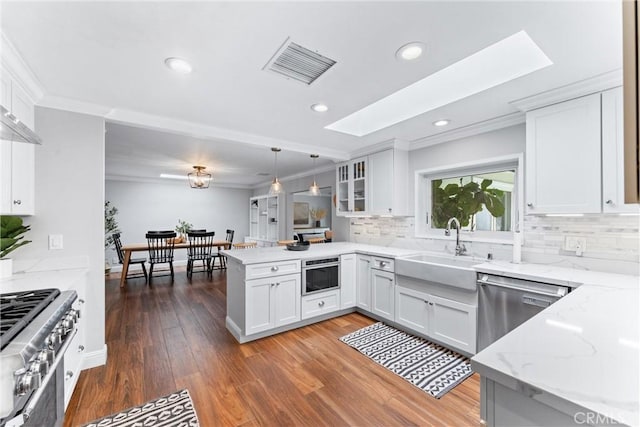 1915 Mariners Dr, Newport Beach, CA 92660 - kitchen featuring a peninsula, dishwasher, ornamental molding, backsplash, and white cabinetry