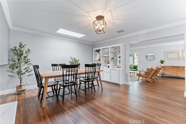 1915 Mariners Dr, Newport Beach, CA 92660 - dining area featuring a skylight, wood finished floors, a chandelier, and crown molding