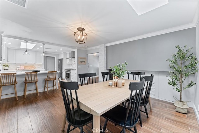 1915 Mariners Dr, Newport Beach, CA 92660 - dining area with a skylight, light wood-type flooring, crown molding, recessed lighting, and a chandelier