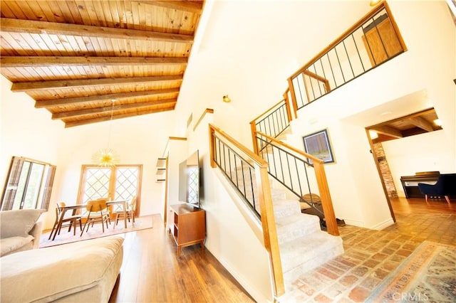 13685 Hidden Valley Rd, Victorville, CA 92395 - staircase with a wood ceiling with exposed beams, a towering ceiling, and a chandelier