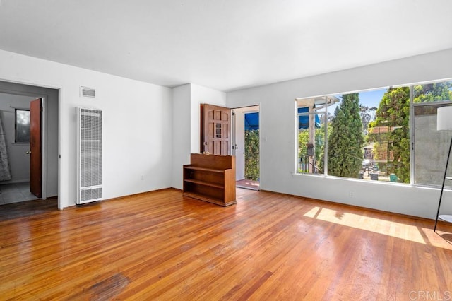 855 Quail St, San Diego, CA 92102 - empty room with a heating unit and wood finished floors