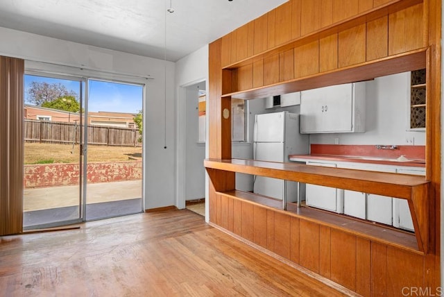855 Quail St, San Diego, CA 92102 - kitchen with freestanding refrigerator, light wood-style flooring, and dishwashing machine