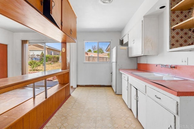 855 Quail St, San Diego, CA 92102 - kitchen featuring open shelves, white cabinetry, light countertops, and light floors