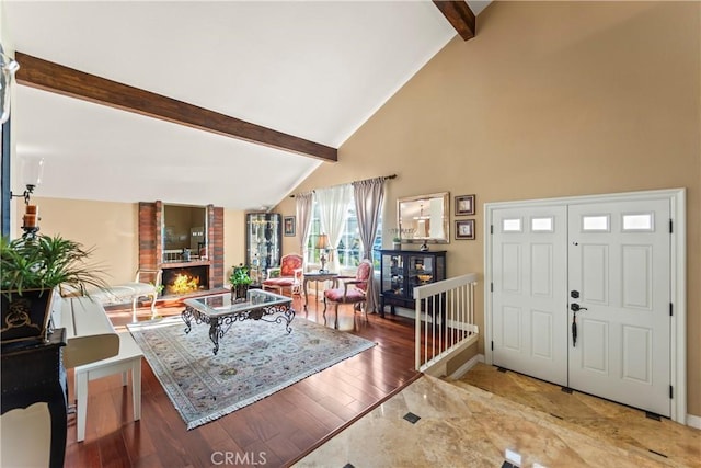 24236 Via, San Clemente, Mission Viejo, CA 92692 - entryway with beamed ceiling, a brick fireplace, high vaulted ceiling, and wood finished floors