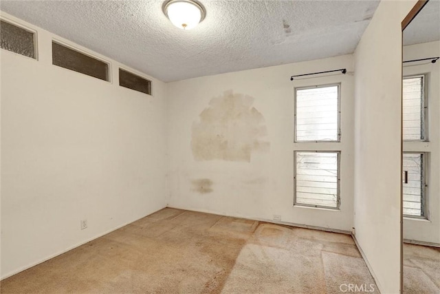 2600 Torrey Pines Rd Unit A13, La Jolla, CA 92037 - carpeted spare room with a textured ceiling and plenty of natural light