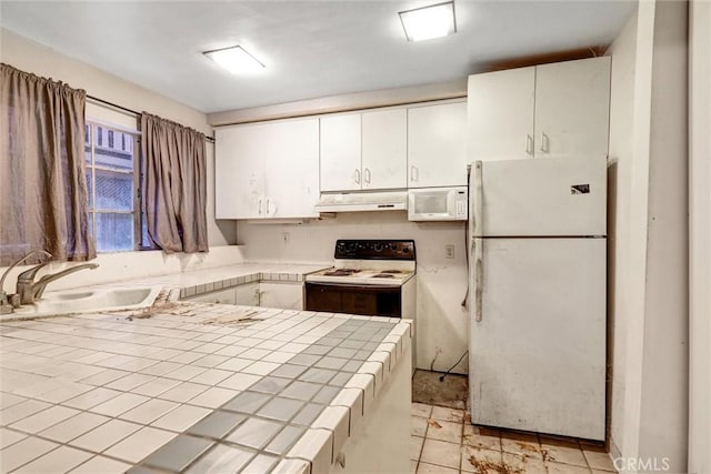 2600 Torrey Pines Rd Unit A13, La Jolla, CA 92037 - kitchen with white appliances, tile counters, under cabinet range hood, and white cabinets