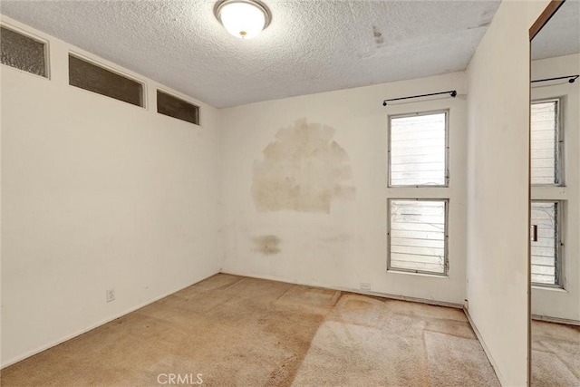 2600 Torrey Pines Rd Unit A13, La Jolla, CA 92037 - unfurnished room featuring carpet floors, a textured ceiling, and plenty of natural light