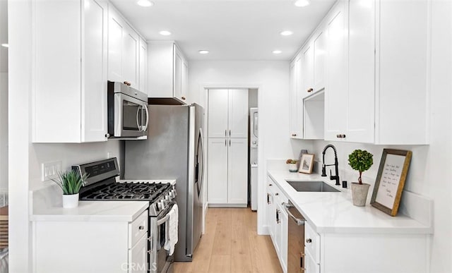 6567 Woodburn Ln Unit 7, Yorba Linda, CA 92886 - kitchen featuring appliances with stainless steel finishes, light wood-style floors, recessed lighting, white cabinets, and light countertops