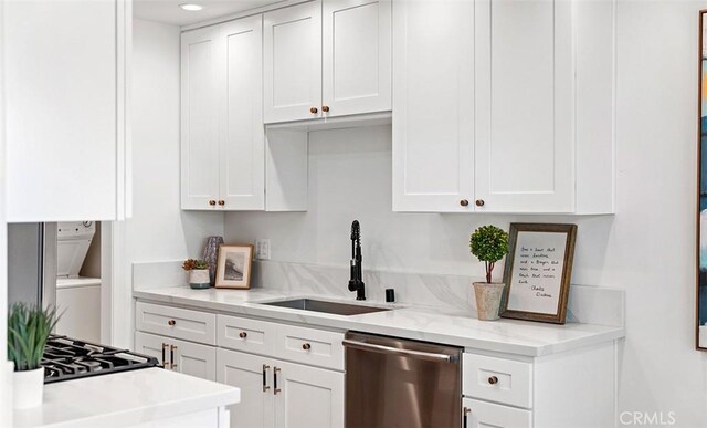 6567 Woodburn Ln Unit 7, Yorba Linda, CA 92886 - kitchen featuring dishwasher, stacked washer and clothes dryer, white cabinets, and recessed lighting