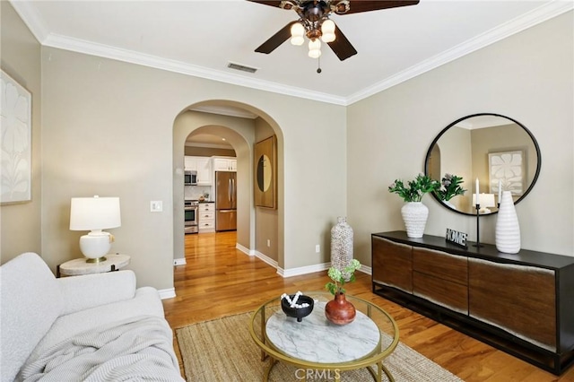 78 Windchime, Irvine, CA 92603 - living room with ceiling fan, light wood finished floors, ornamental molding, and arched walkways