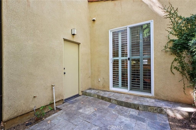 78 Windchime, Irvine, CA 92603 - property entrance featuring stucco siding and a patio