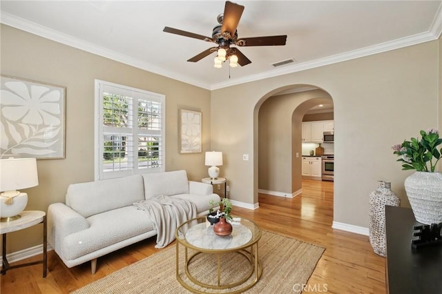 78 Windchime, Irvine, CA 92603 - living room with arched walkways, light wood finished floors, crown molding, and a ceiling fan