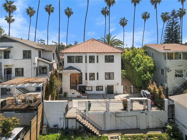 1409 Laveta, Los Angeles, CA 90026 - view of front of house with stairway, stucco siding, a fenced backyard, and a patio area