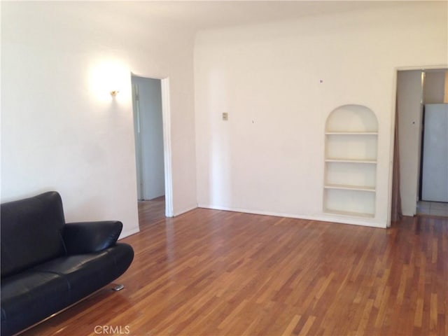 1237 S 3rd St, Alhambra, CA 91801 - living room featuring built in shelves and wood finished floors