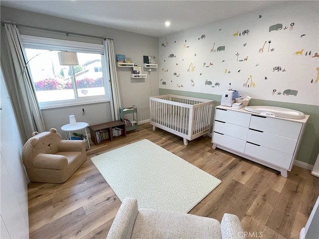9749 Reseda Blvd Unit 13, Northridge, CA 91324 - bedroom with a crib, radiator, light wood-style flooring, and recessed lighting